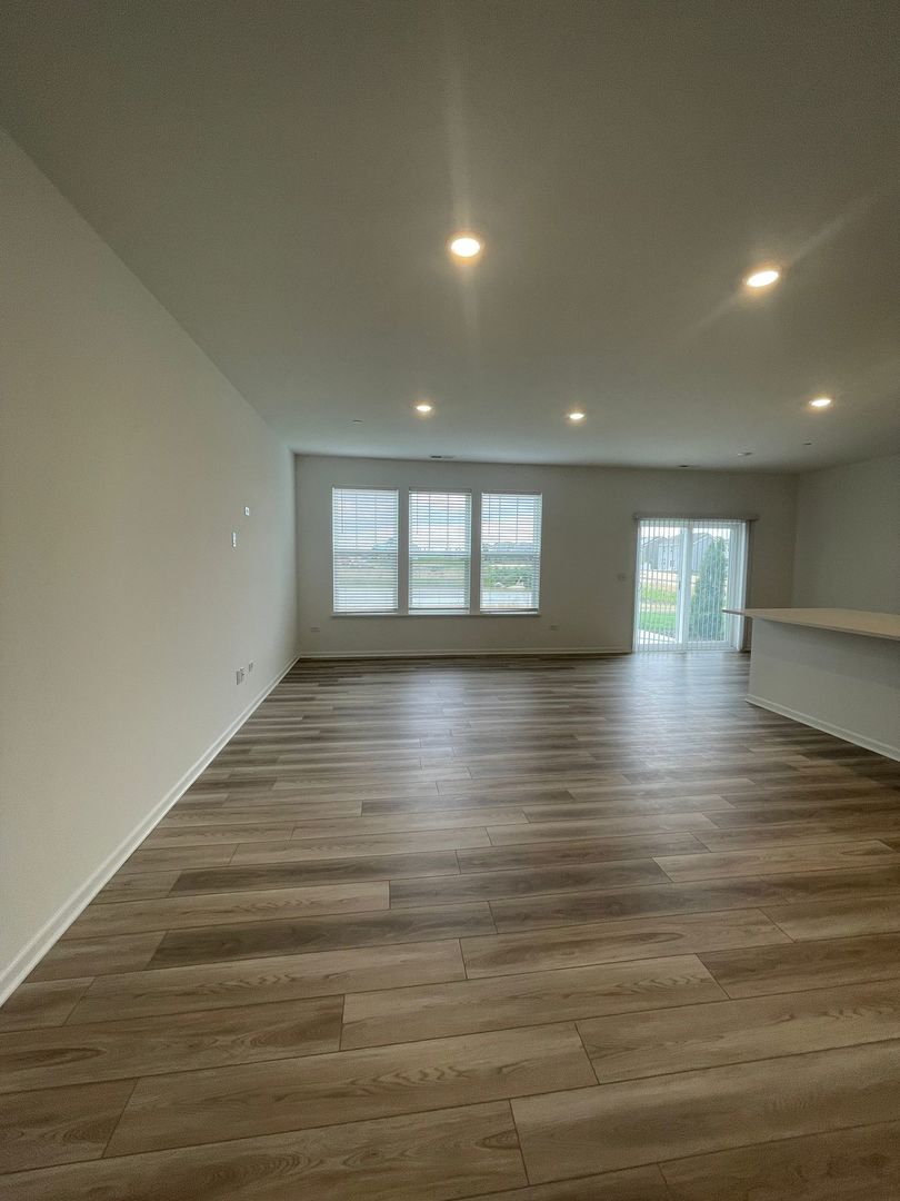 104 Henderson Street Oswego, IL 60543 - Photo 9 of 21 a view of empty room with wooden floor