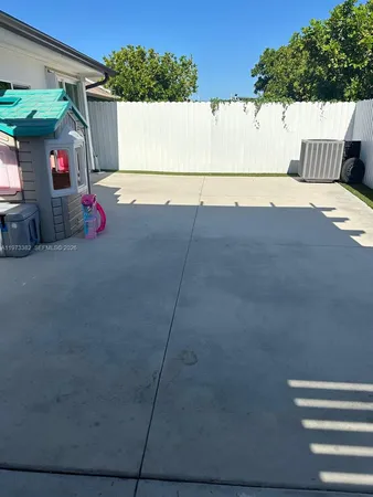 a view of backyard with wooden fence