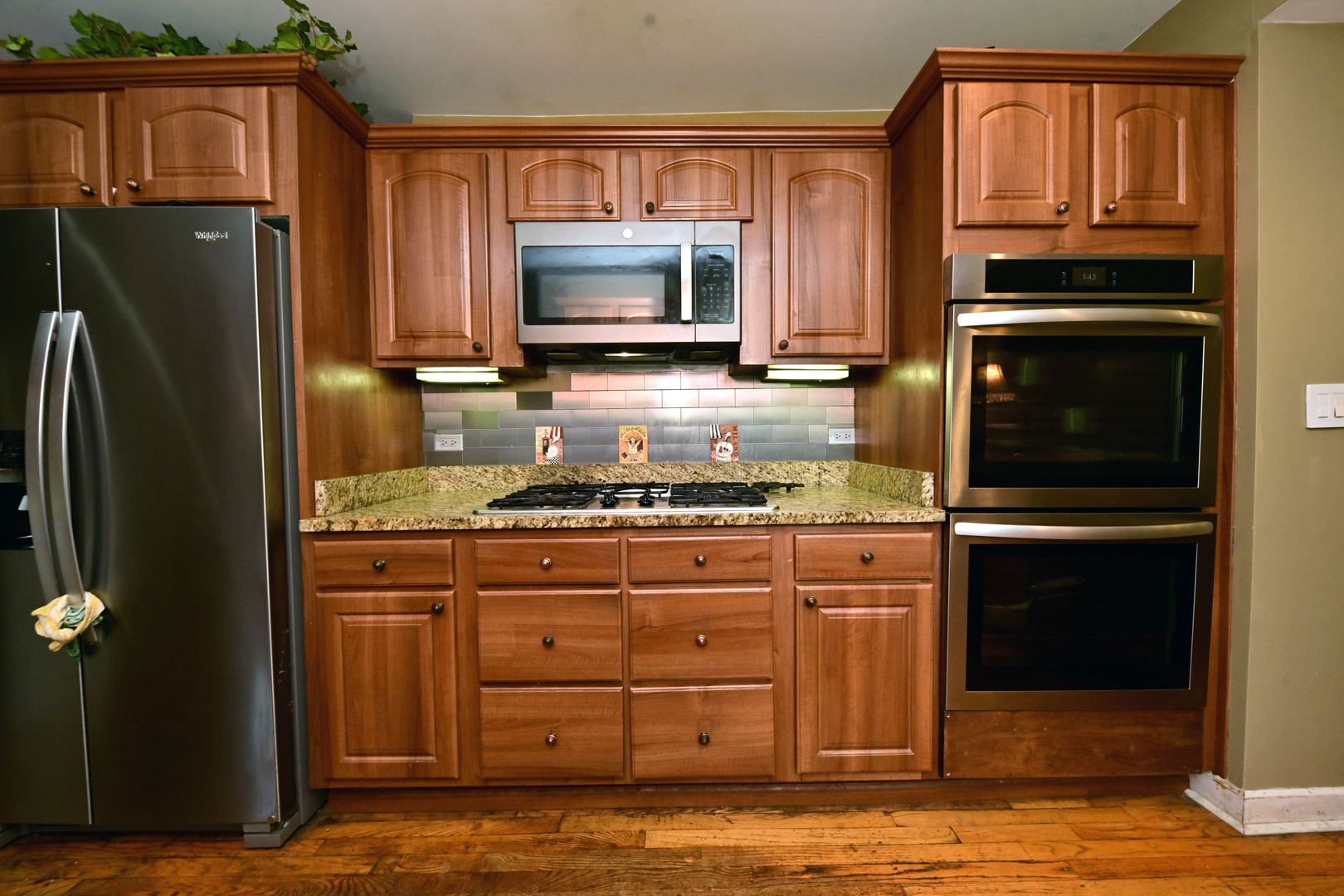 2140 Beechnut Road Northbrook, IL 60062 - Photo 13 of 33 a kitchen with granite countertop a refrigerator stove and microwave