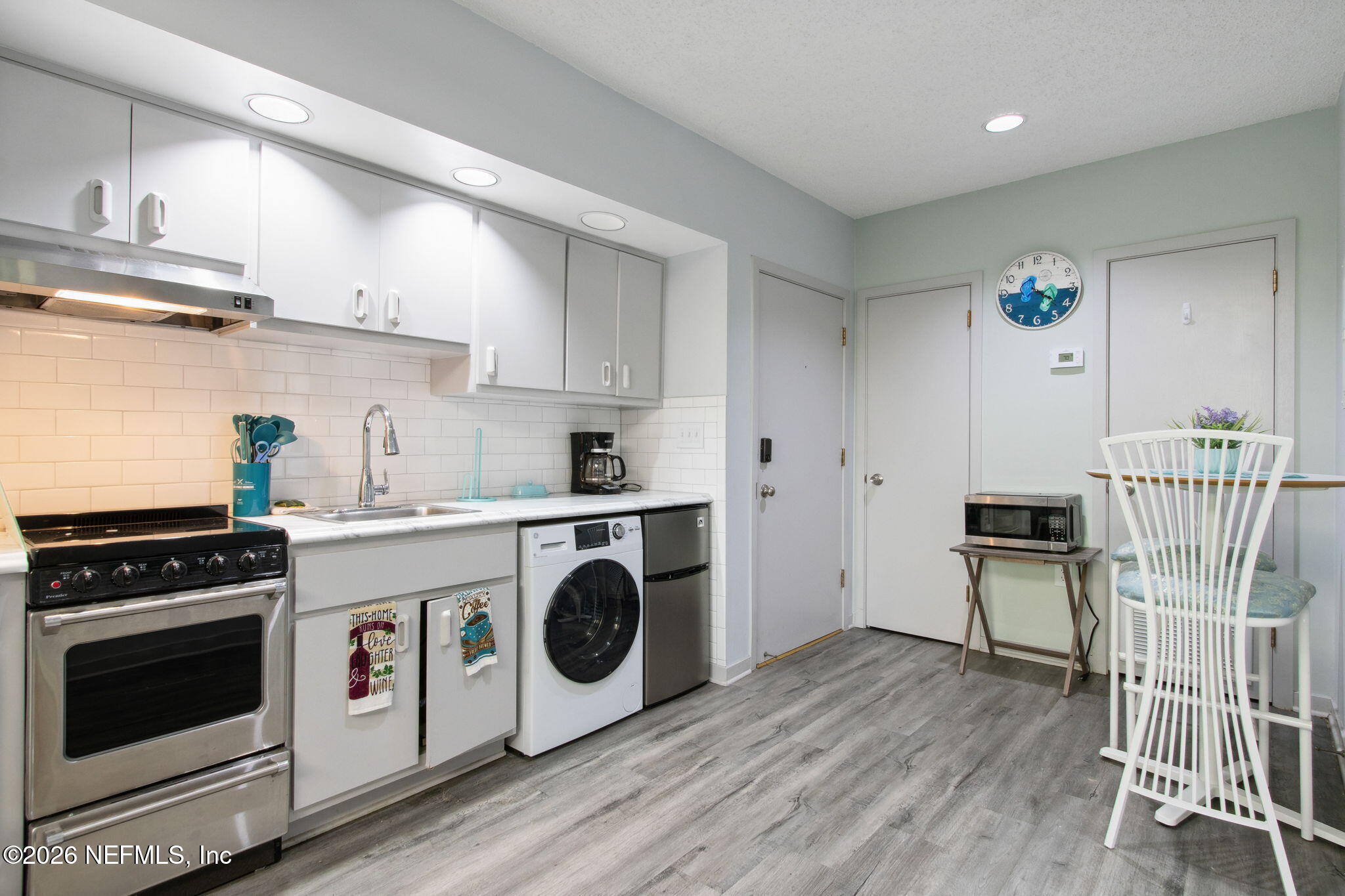 3165 Ravines Road, Unit 3601 Middleburg, FL 32068 - Photo 13 of 23 a kitchen with a stove a refrigerator and wooden floor