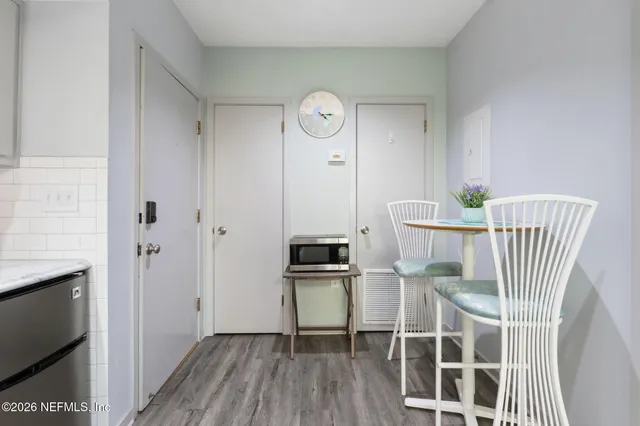 a view of a room with wooden floor and workspace
