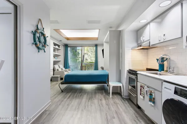 a bedroom with furniture and a wooden floor