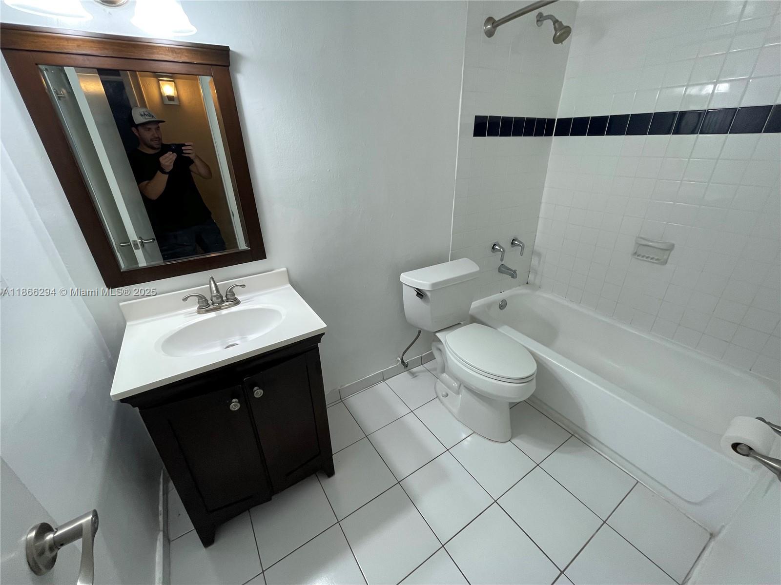 8605 Southwest 68th Court, Unit 1 Pinecrest, FL 33156 - Photo 7 of 20 a bathroom with a sink vanity mirror and toilet