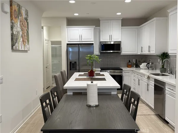 a kitchen with appliances cabinets and a counter top space