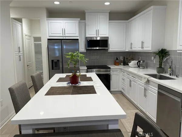 a kitchen with a table chairs and a refrigerator