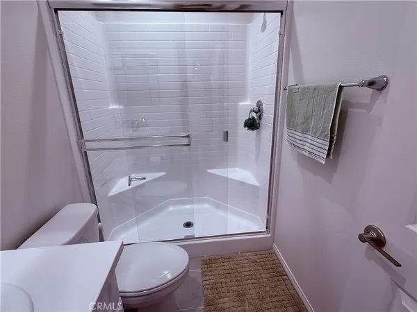 a bedroom with a bed and lamp