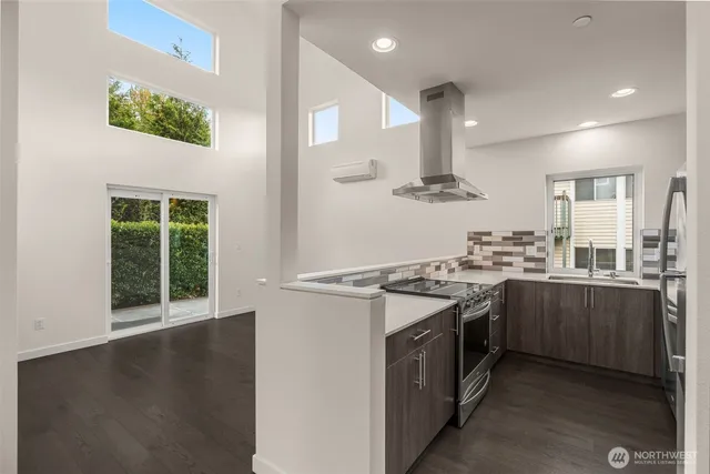 a kitchen with stainless steel appliances granite countertop a stove a sink and a refrigerator