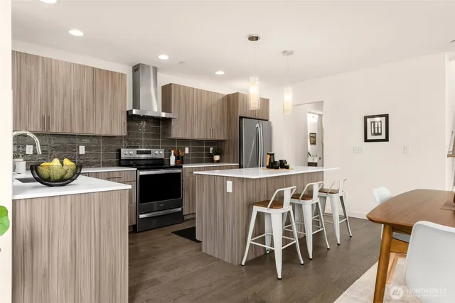 a kitchen with a dining table chairs and cabinets