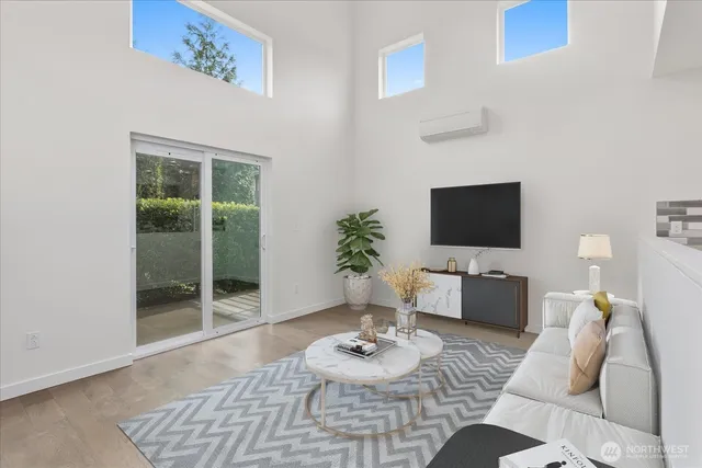 a living room with furniture a flat screen tv and a table