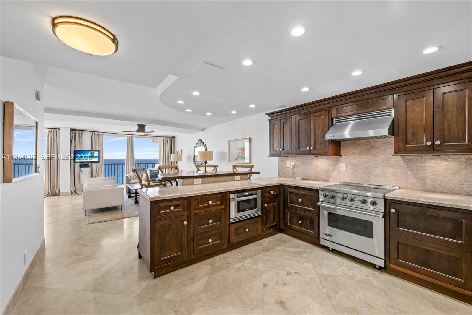 400 North Surf Road, Unit 905 Hollywood, FL 33019 - Photo 11 of 24 a large kitchen with stainless steel appliances granite countertop a stove and a sink
