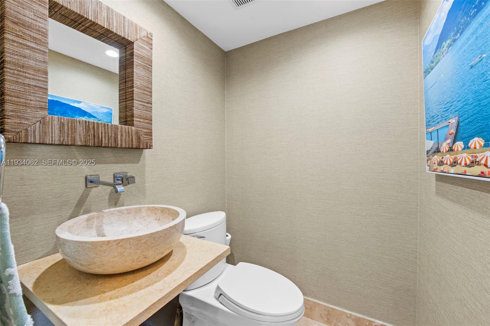 400 North Surf Road, Unit 905 Hollywood, FL 33019 - Photo 14 of 24 a bathroom with a toilet a sink and mirror