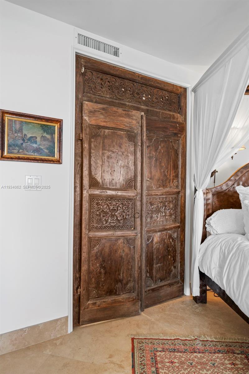 400 North Surf Road, Unit 905 Hollywood, FL 33019 - Photo 19 of 24 a bedroom with a bed and a mirror