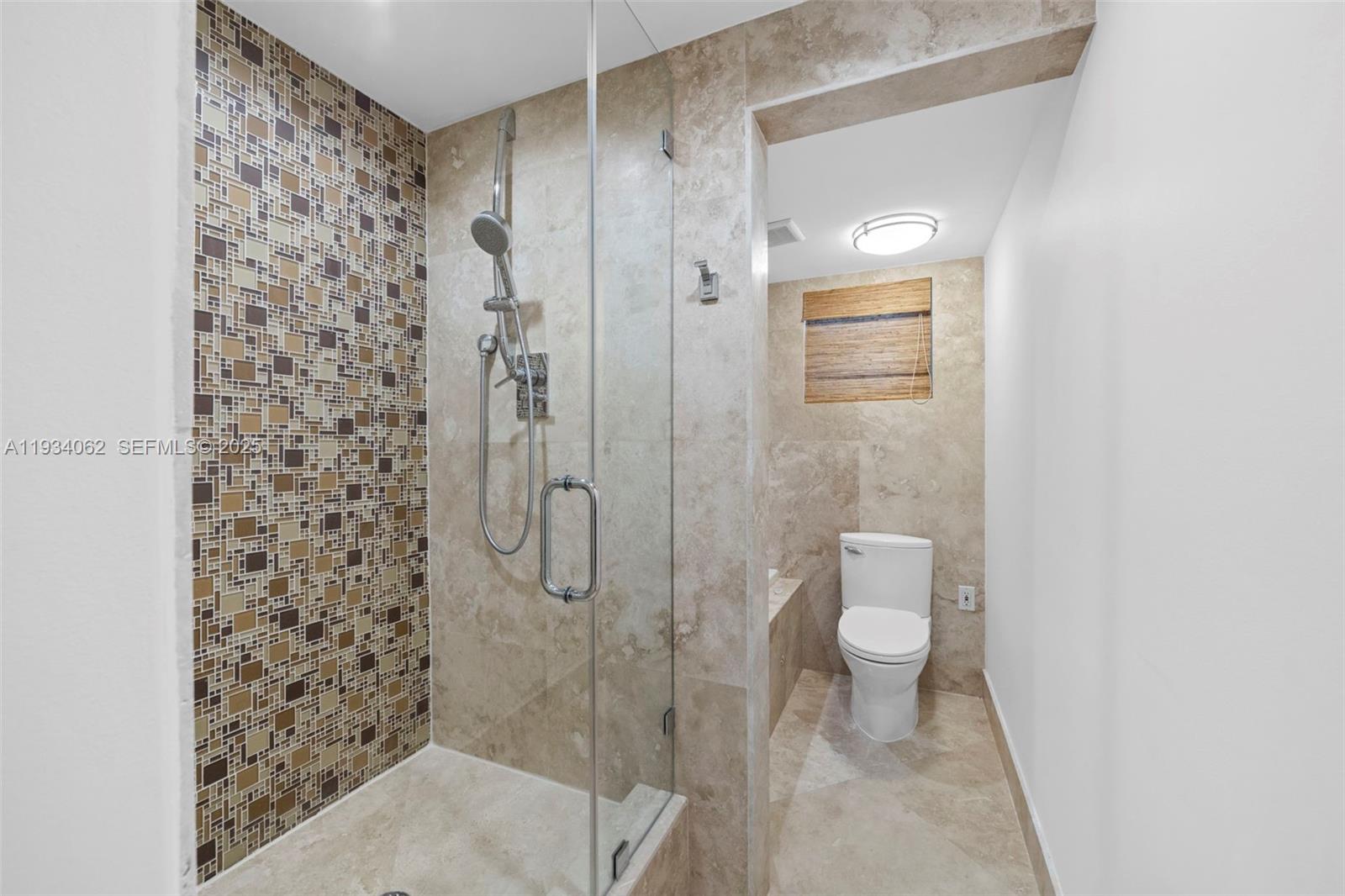 400 North Surf Road, Unit 905 Hollywood, FL 33019 - Photo 22 of 24 a bathroom with a shower and a toilet