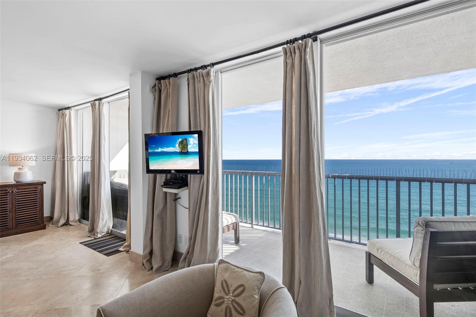 400 North Surf Road, Unit 905 Hollywood, FL 33019 - Photo 9 of 24 a living room with furniture and a floor to ceiling window