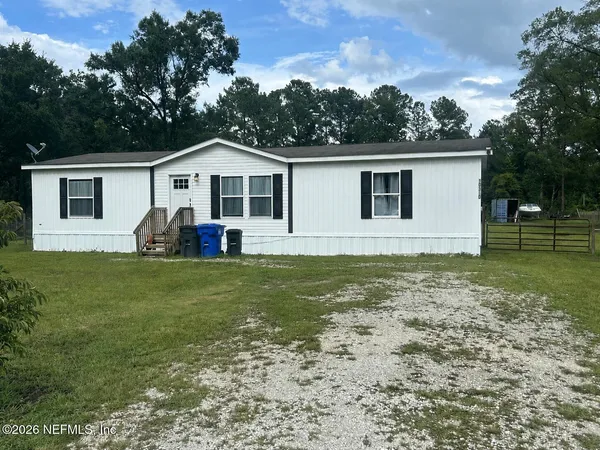 a view of a house with a backyard