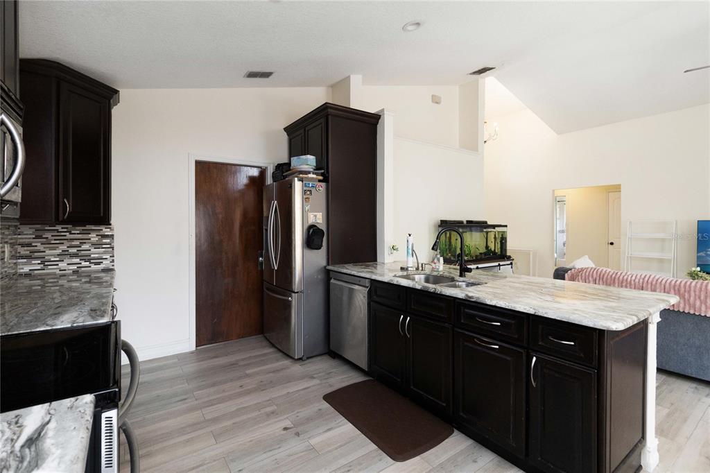 1647 Riveredge Road Oviedo, FL 32766 - Photo 11 of 28 a kitchen with a sink refrigerator and microwave