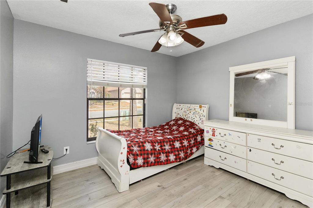 1647 Riveredge Road Oviedo, FL 32766 - Photo 17 of 28 a bedroom with a large bed and a flat tv screen on dresser