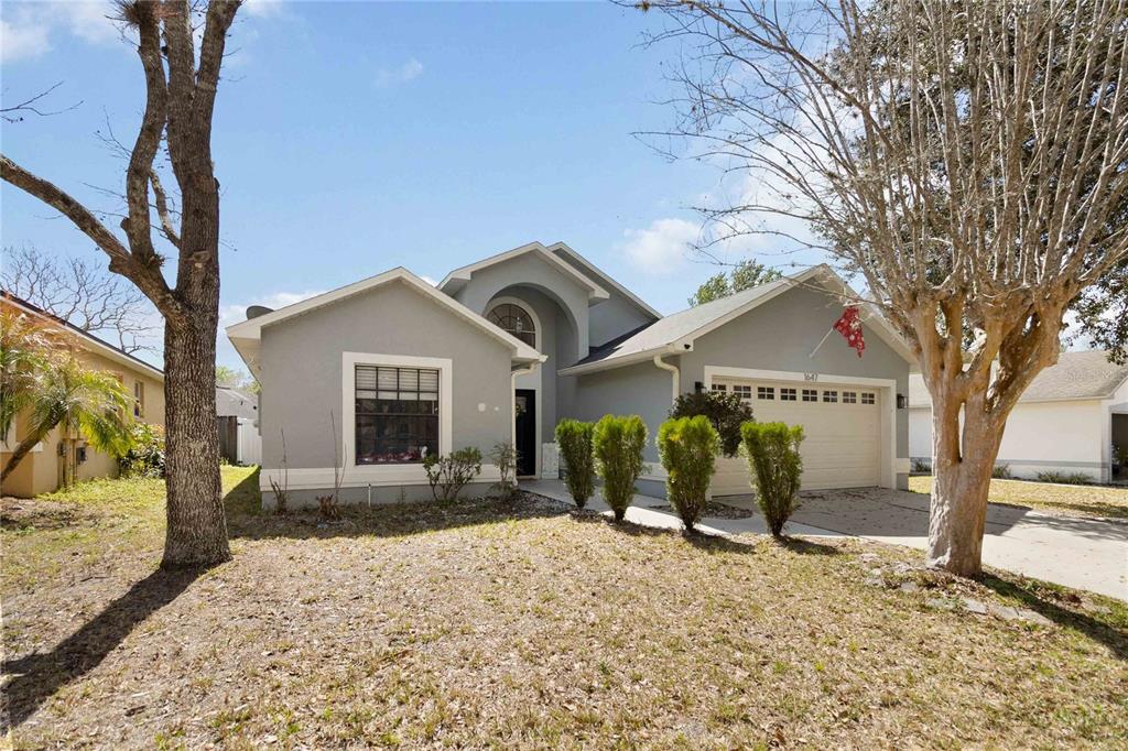 1647 Riveredge Road Oviedo, FL 32766 - Photo 2 of 28 a front view of a house with a yard and garage