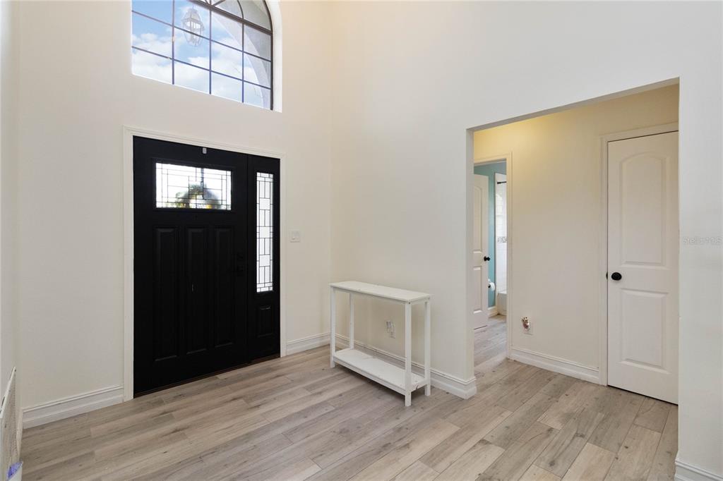 1647 Riveredge Road Oviedo, FL 32766 - Photo 4 of 28 an empty room with wooden floor and windows