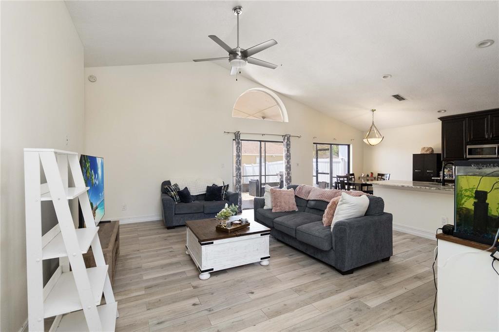 1647 Riveredge Road Oviedo, FL 32766 - Photo 5 of 28 a living room with furniture a fireplace and a chandelier