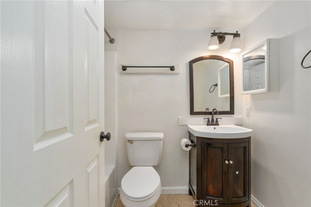 3535 Banbury Drive, Unit 119 Riverside, CA 92505 - Photo 15 of 23 a bathroom with a toilet a sink and mirror