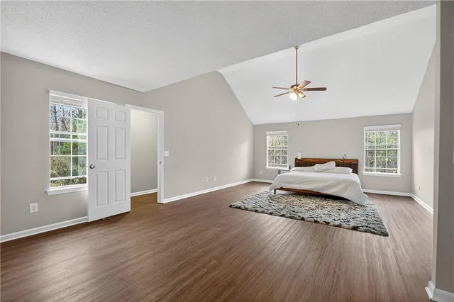 a spacious bedroom with a bed and window