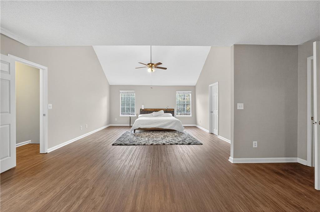 336 Riverview Court Fairburn, GA 30213 - Photo 17 of 18 a bedroom with a bed and wooden floor
