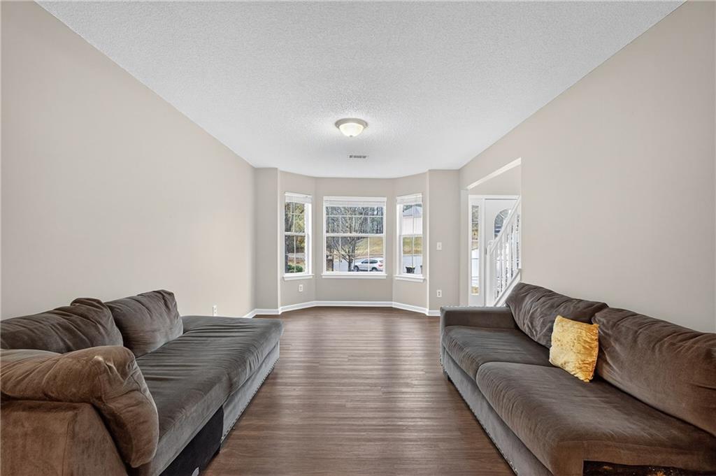 336 Riverview Court Fairburn, GA 30213 - Photo 3 of 18 a living room with furniture and a large window