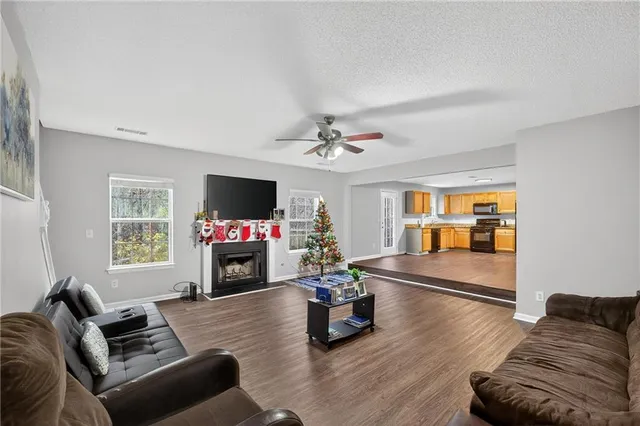 a living room with furniture flat screen tv and a fireplace