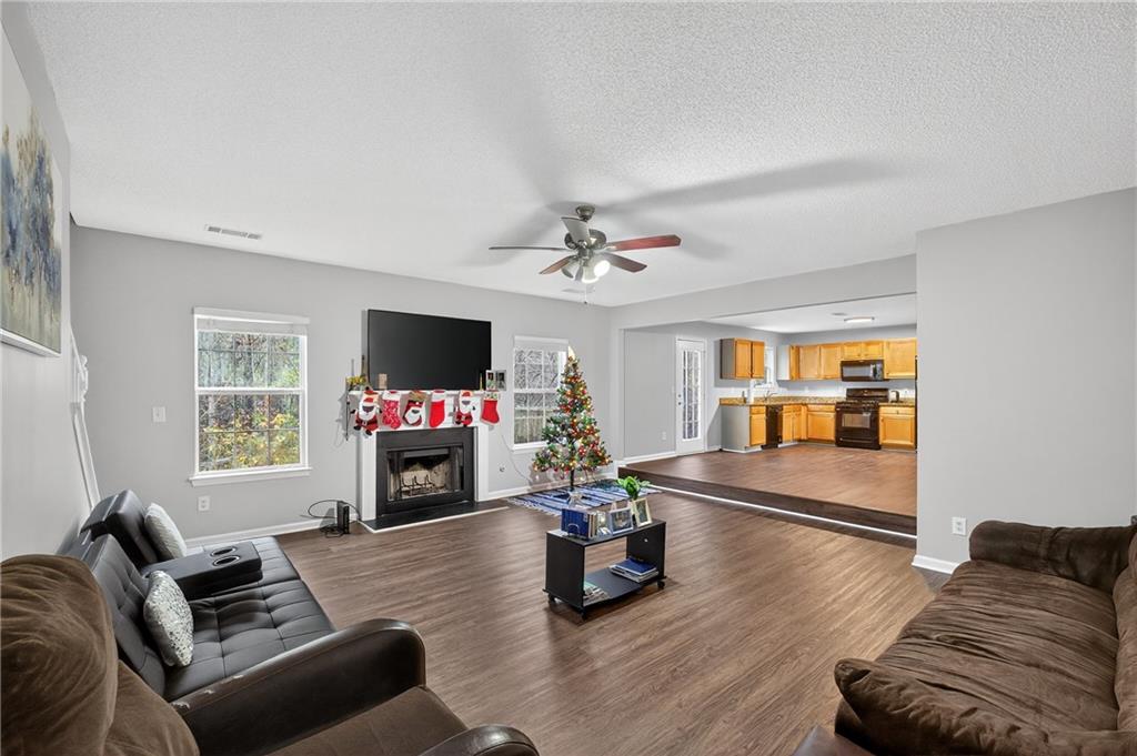 336 Riverview Court Fairburn, GA 30213 - Photo 10 of 18 a living room with furniture flat screen tv and a fireplace