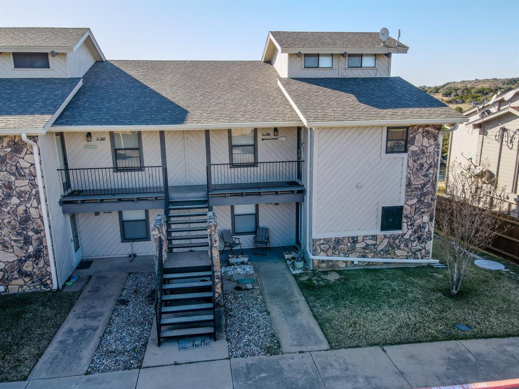 3037 Hells Gate Loop, Unit C208 Strawn, TX 76475 - Photo 16 of 23 a front view of a house with garden