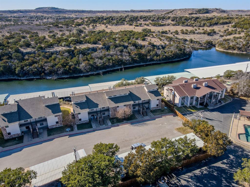 3037 Hells Gate Loop, Unit C208 Strawn, TX 76475 - Photo 22 of 23 an aerial view of a house with lake view