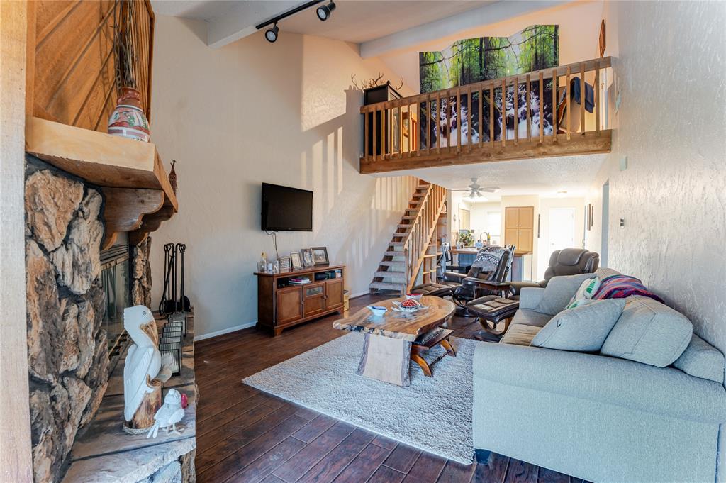 3037 Hells Gate Loop, Unit C208 Strawn, TX 76475 - Photo 8 of 23 a living room with furniture and a flat screen tv