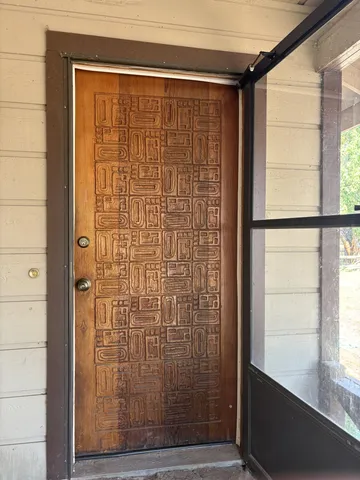 a view of a room with wooden floor