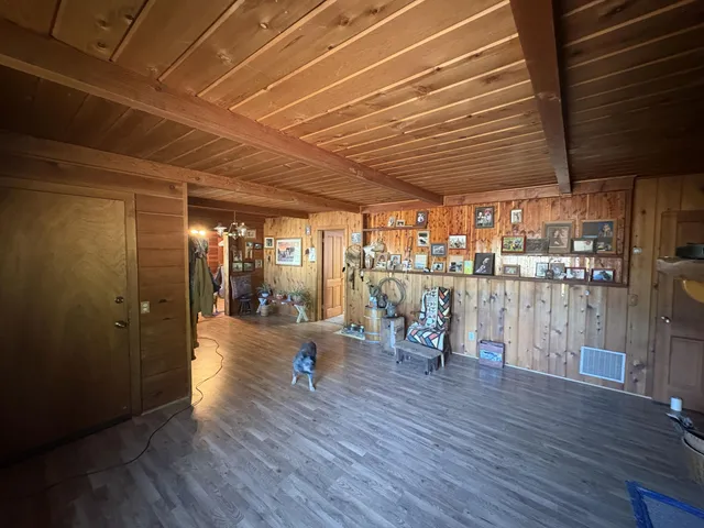 a view of a room with furniture and wooden floor