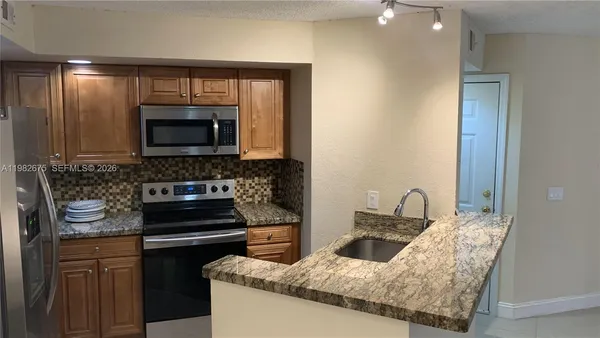 a kitchen with a stove and a microwave