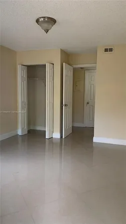 an empty room with closet area