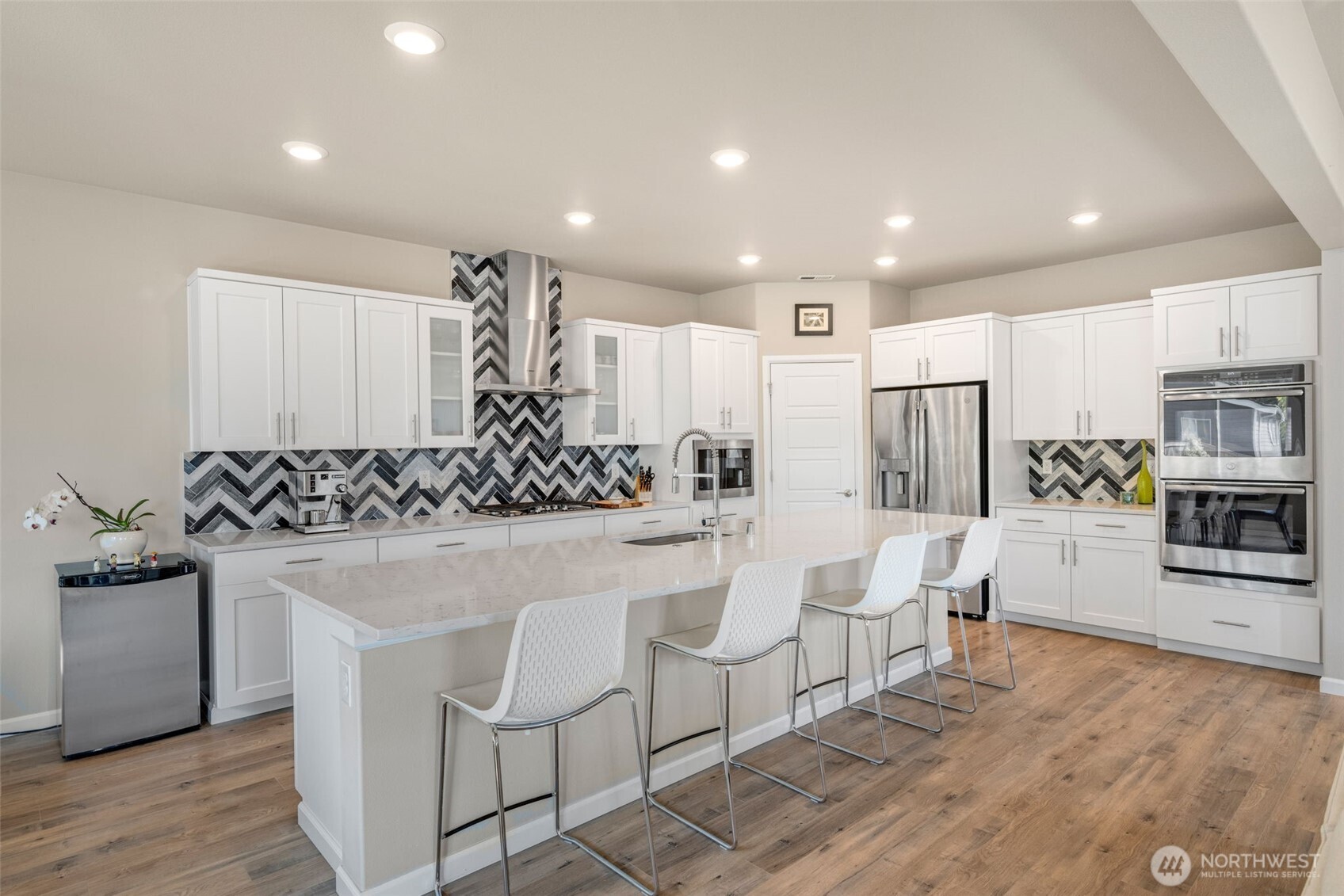 216 178th Street Southeast Bothell, WA 98012 - Photo 10 of 40 a kitchen with white cabinets and stainless steel appliances