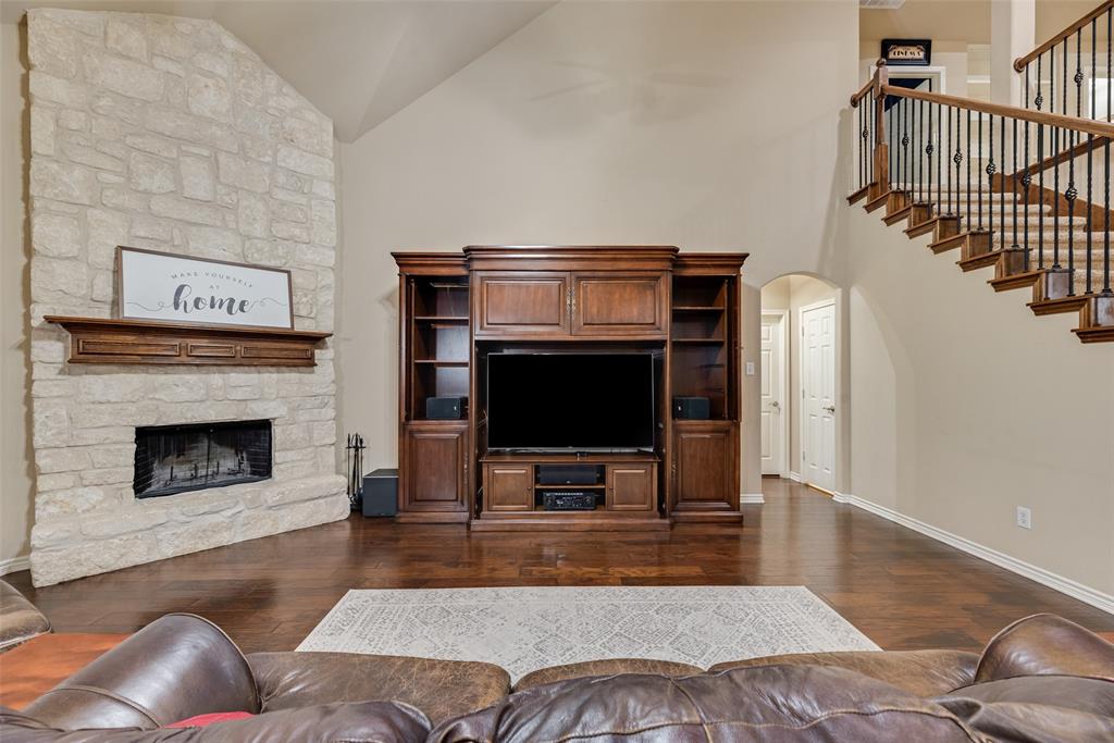 11920 Vienna Apple Road Fort Worth, TX 76244 - Photo 12 of 40 Expansive living room with hardwood floors, wood burning fireplace with gas starter, soaring vaulted ceilings and ceiling fan at 11920 Vienna Apple in Villages of Woodland Springs community in North Fort Worth