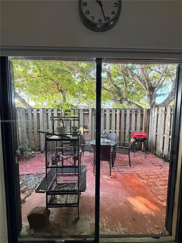 a view of a porch with furniture and a yard