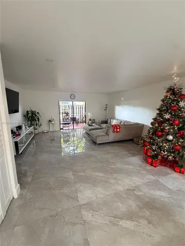 a living room with furniture and flowers