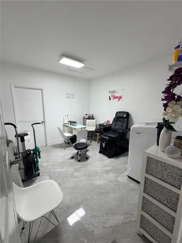 a living room with furniture a rug and a potted plant