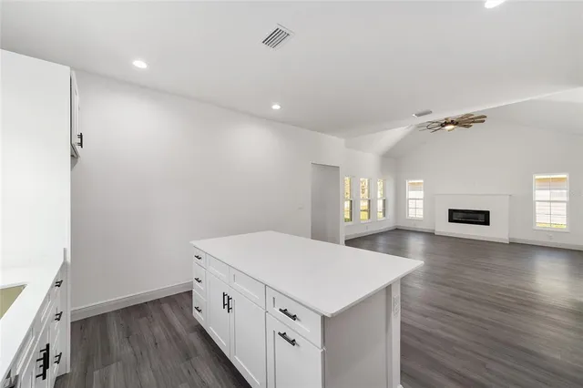 a kitchen with a wooden floor and window