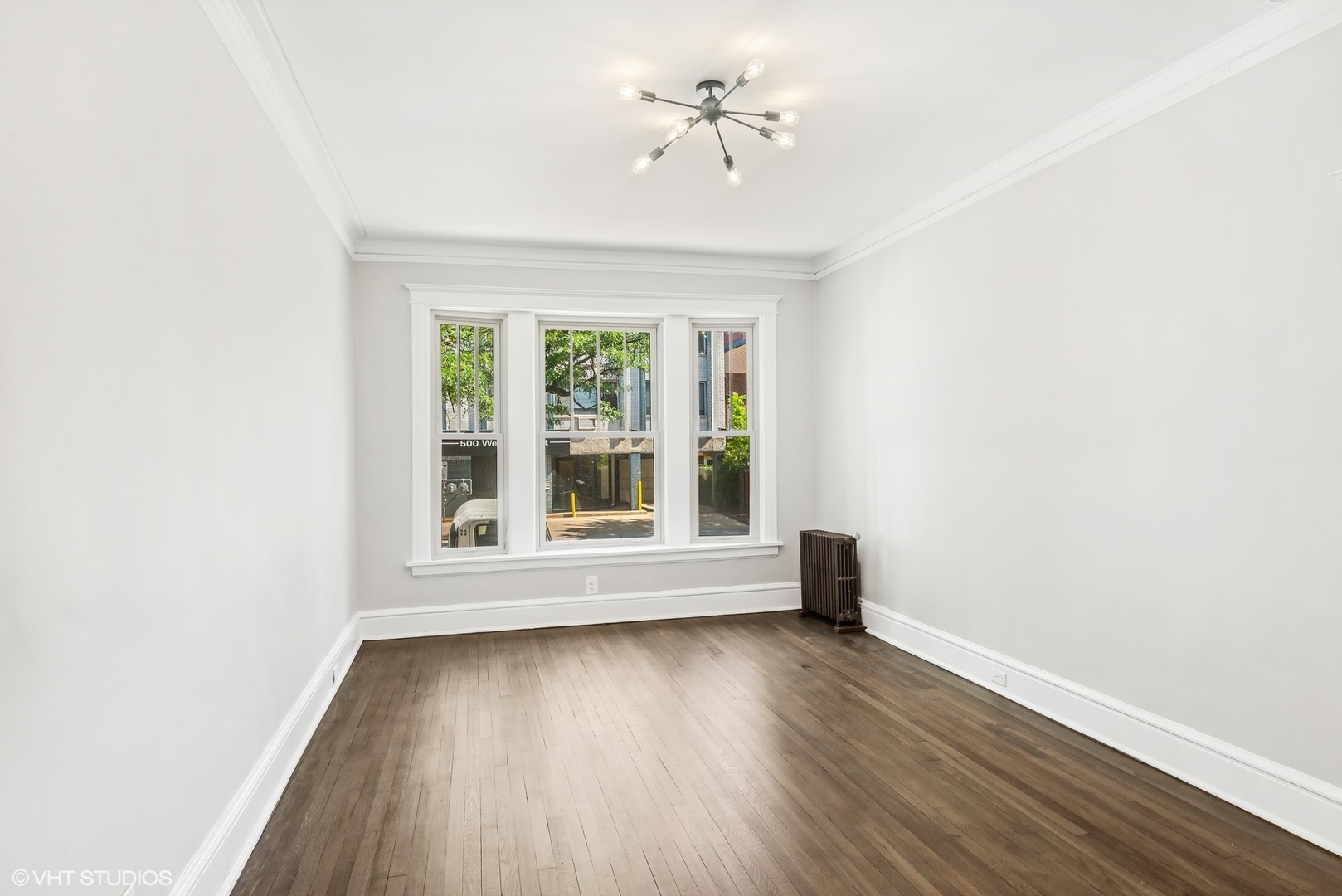 501 West Belmont Avenue, Unit 1 Chicago, IL 60657 - Photo 12 of 17 an empty room with wooden floor and windows