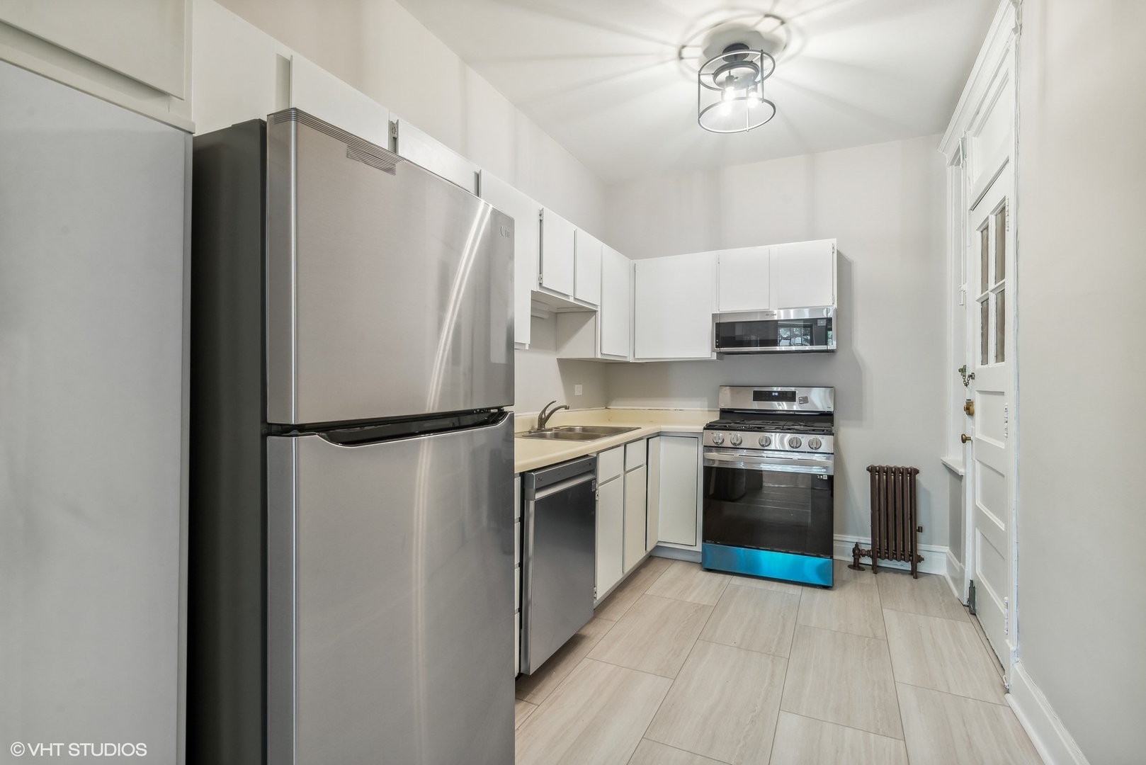 501 West Belmont Avenue, Unit 1 Chicago, IL 60657 - Photo 14 of 17 a kitchen with stainless steel appliances a refrigerator sink and stove