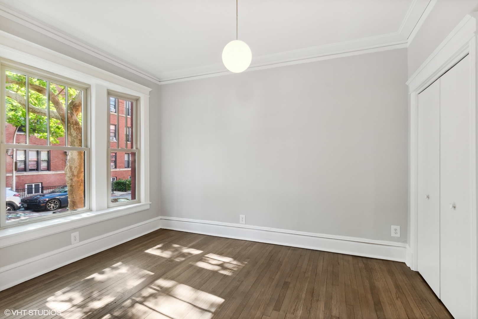 501 West Belmont Avenue, Unit 1 Chicago, IL 60657 - Photo 15 of 17 a view of an empty room with wooden floor and a window