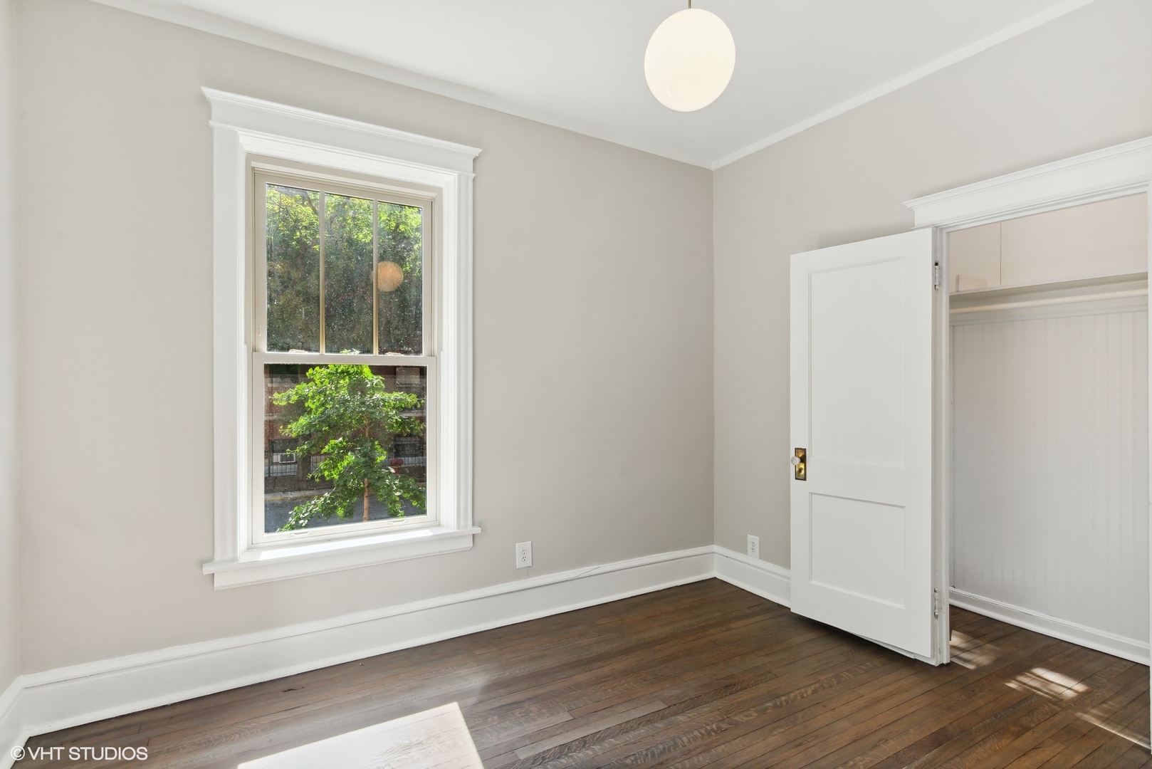 501 West Belmont Avenue, Unit 1 Chicago, IL 60657 - Photo 16 of 17 an empty room with wooden floor and windows