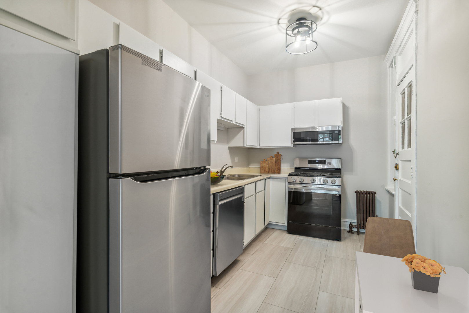 501 West Belmont Avenue, Unit 1 Chicago, IL 60657 - Photo 3 of 17 a kitchen with stainless steel appliances a refrigerator sink and microwave