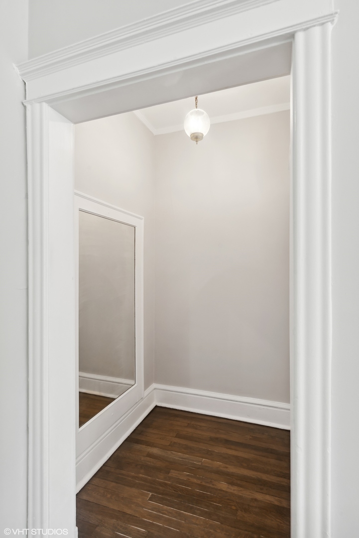 501 West Belmont Avenue, Unit 1 Chicago, IL 60657 - Photo 7 of 17 a view of an empty room with wooden floor