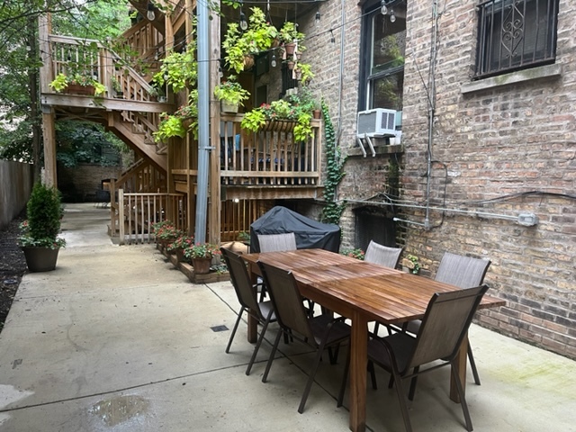 501 West Belmont Avenue, Unit 1 Chicago, IL 60657 - Photo 9 of 17 a view of a patio with a table and chairs